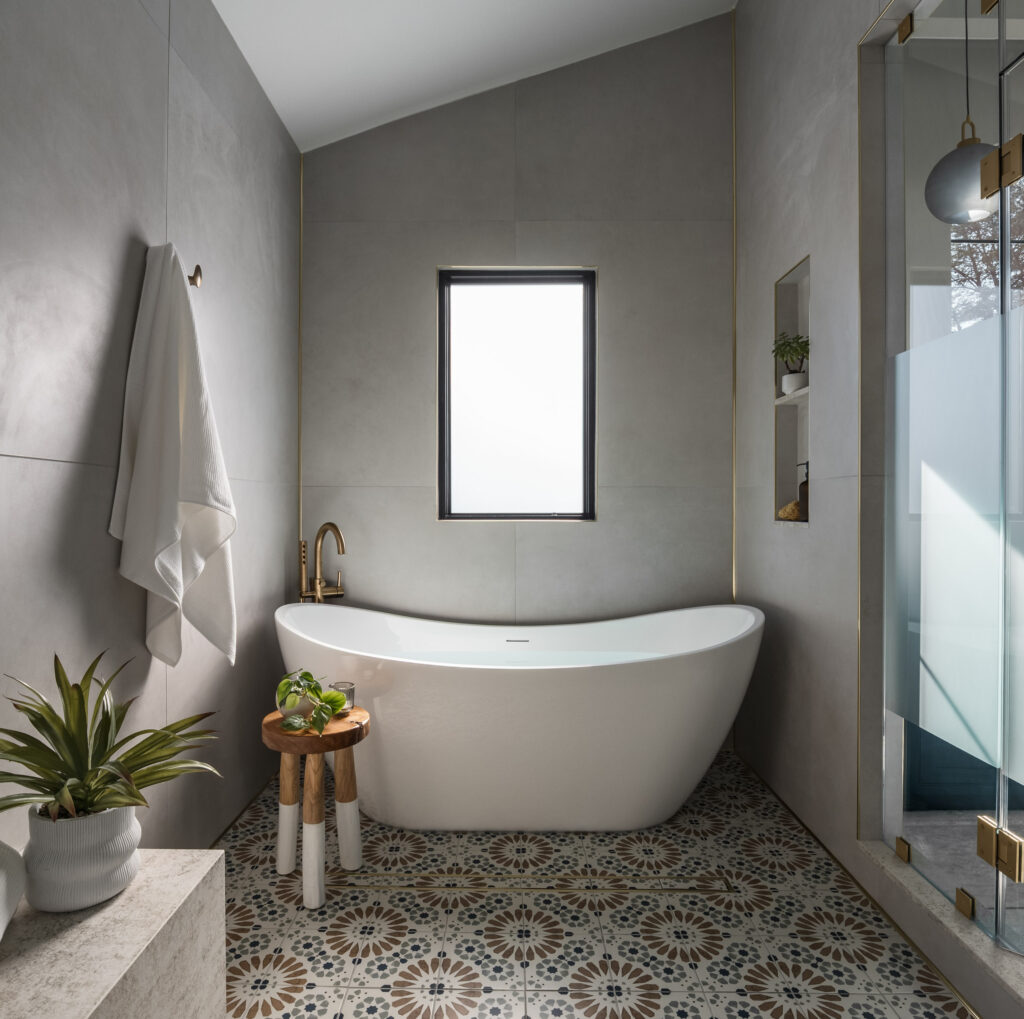 Grey luxury shower with gold fixtures and a large tub installed by Sage Construction in Fairfax VA